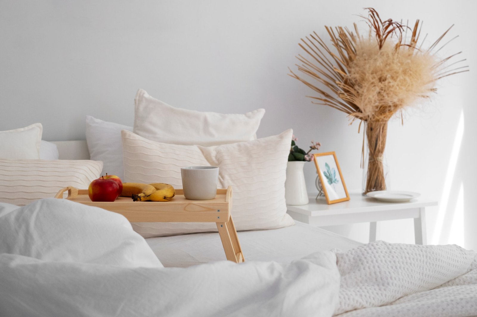 Bed arrangement with fresh bed sheets and a breakfast tray.