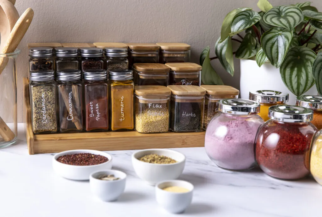 Organized spices in glass bottles.