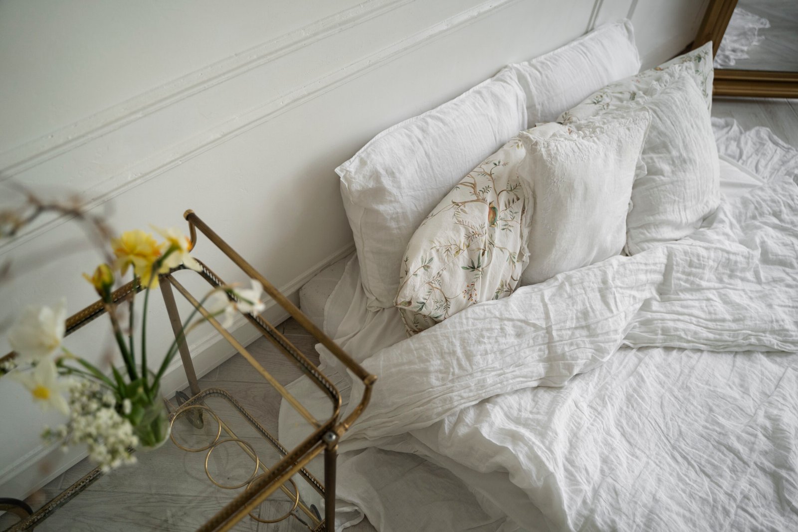 Bed arrangement with white bed sheets. 