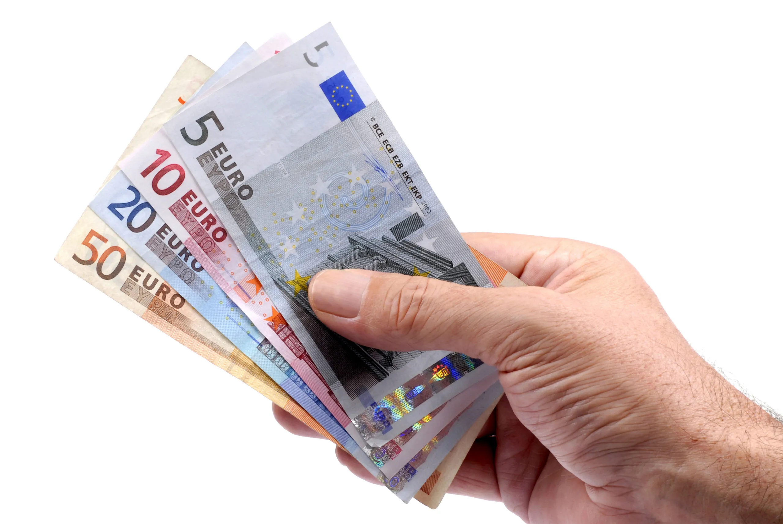 Selection of euro notes held in a male hand isolated on a white background.