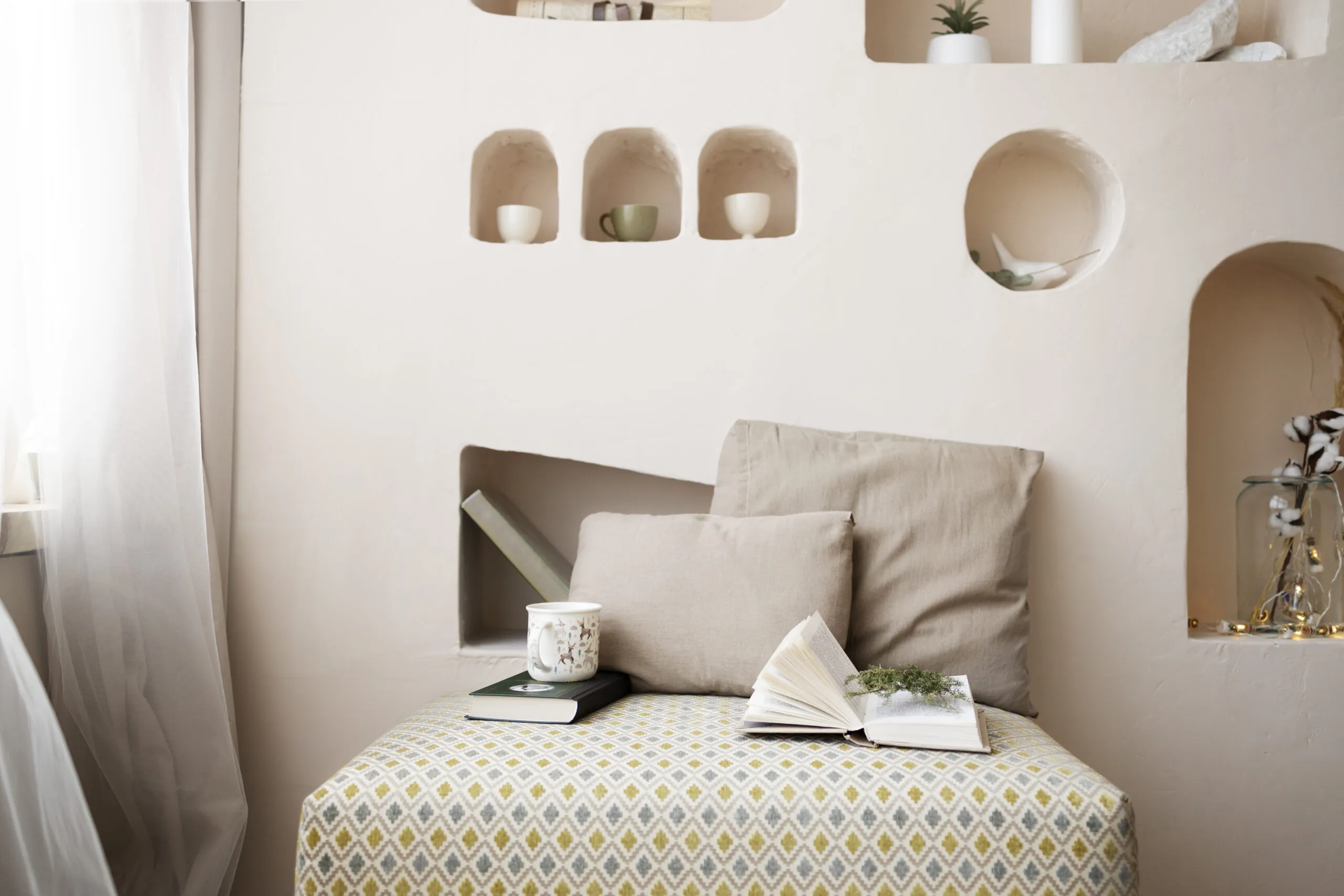 Winter home lifestyle with cozy pillows and books.