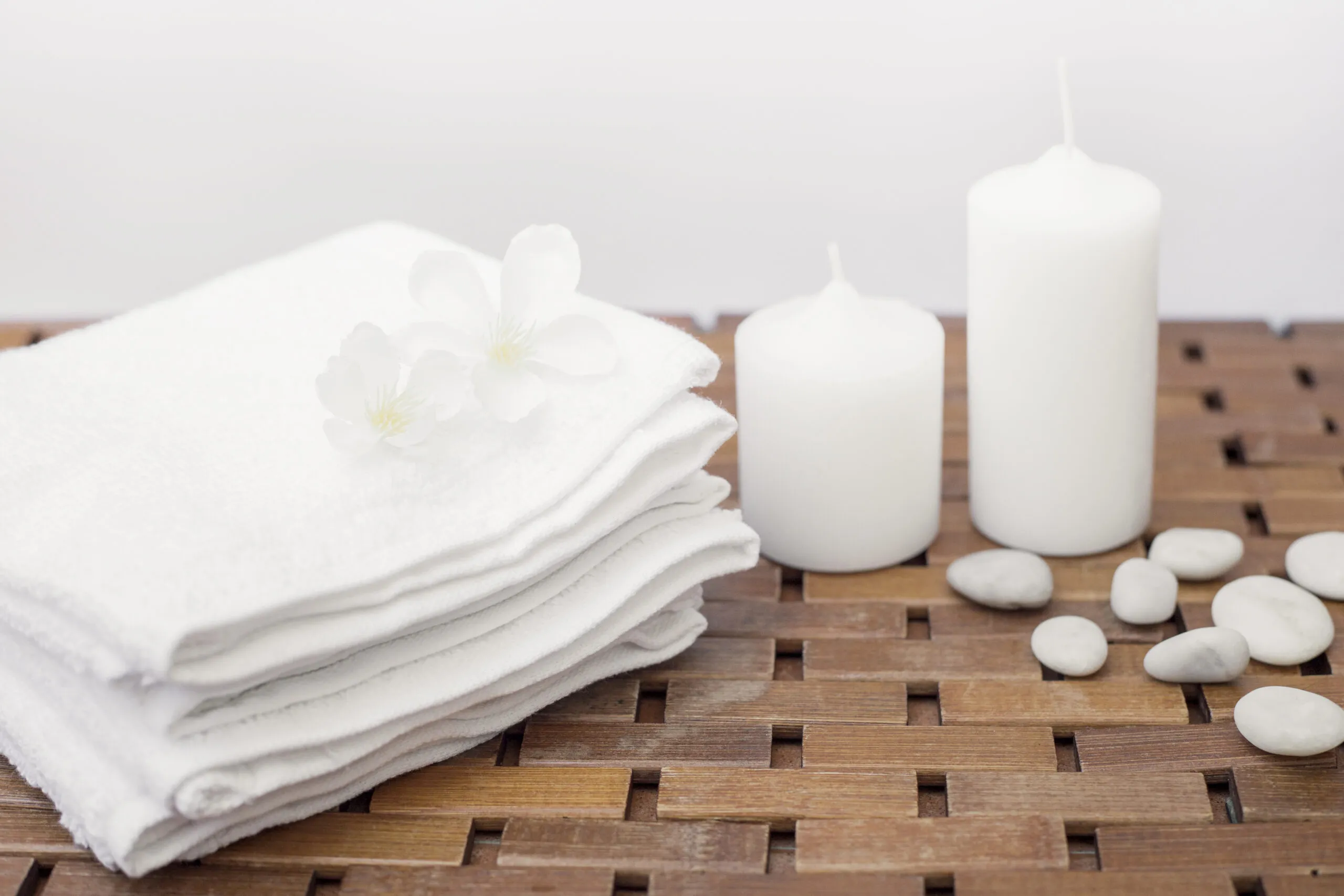 White towels and candles, creating a spa-like bathroom.