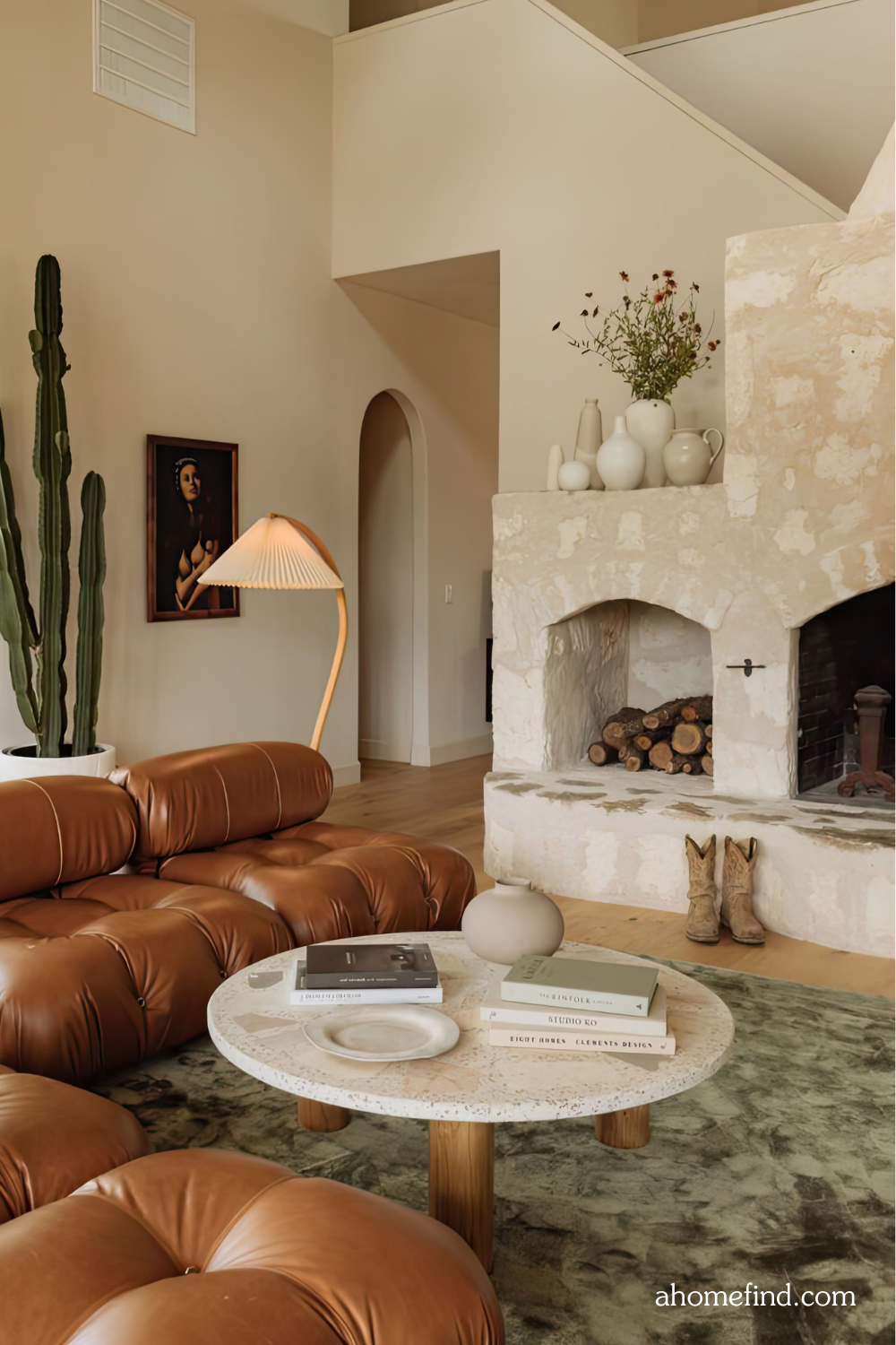 A mid century modern living room with a leather brown sofa, a floor lamp, a large rug and a coffee table with decorative items on it. 