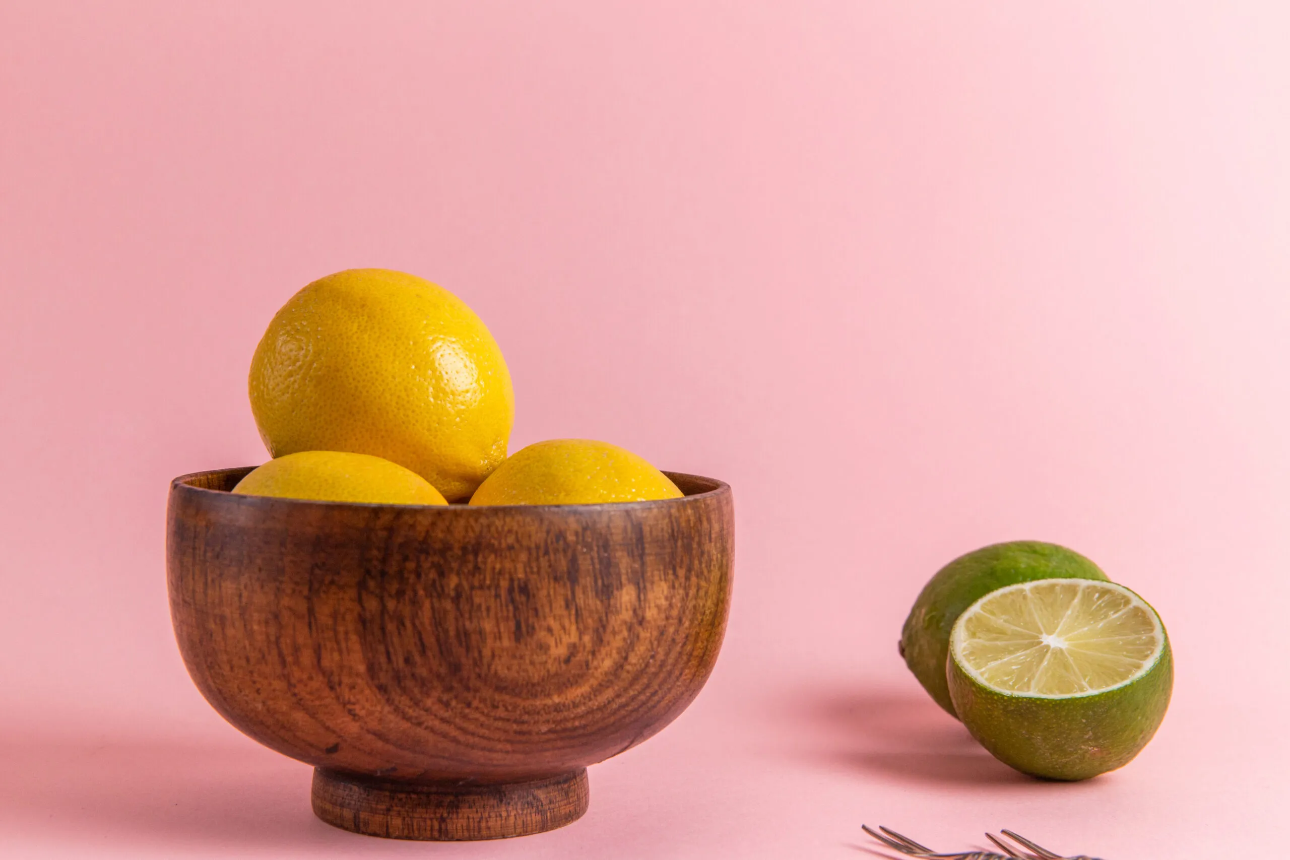 Lemons in a wooden bowl.