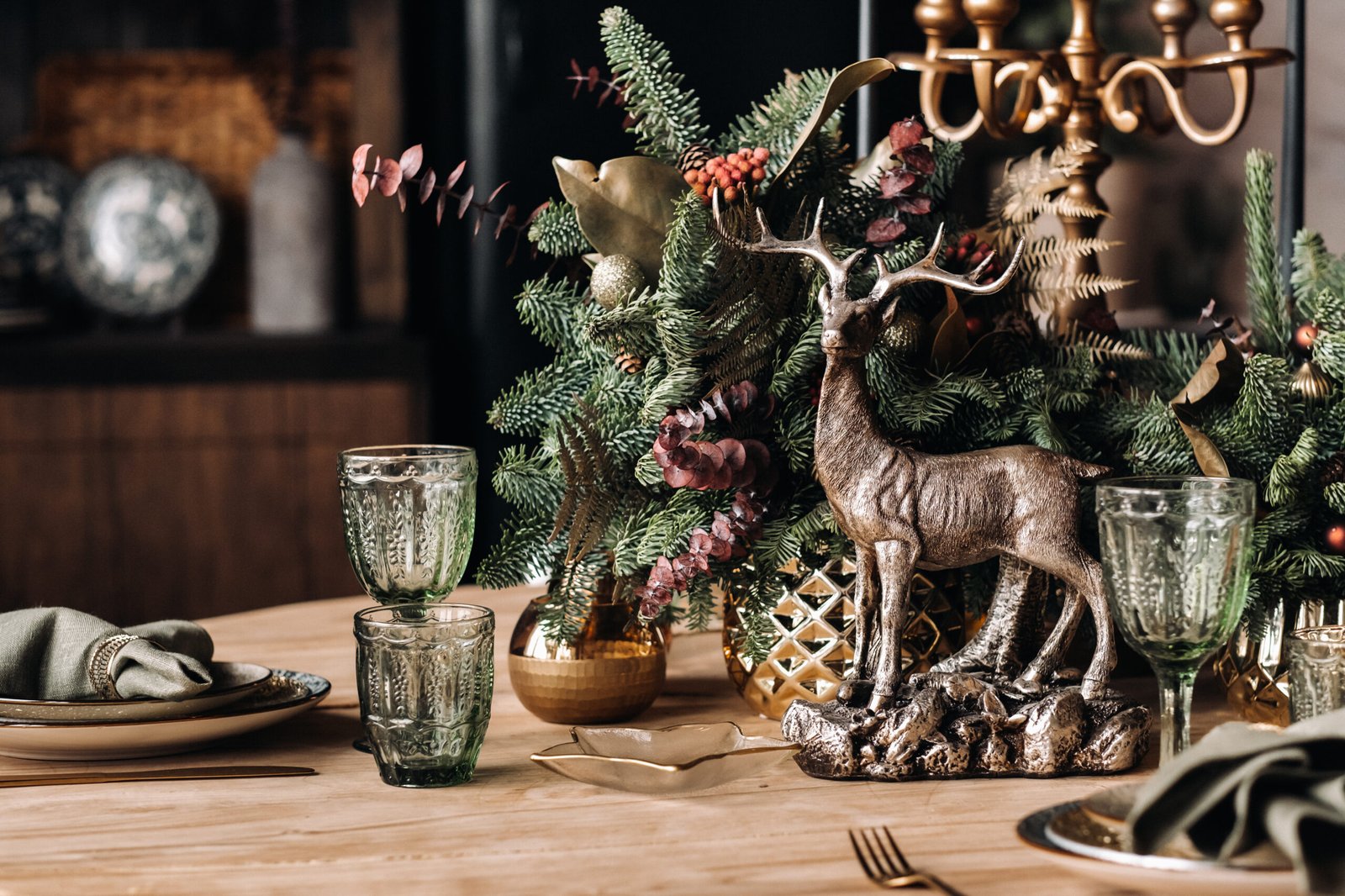 How To Decorate A Dining Room Table For Christmas. Christmas table decoration, Banquet table with glasses before serving food, crystal glasses and decorative deer.