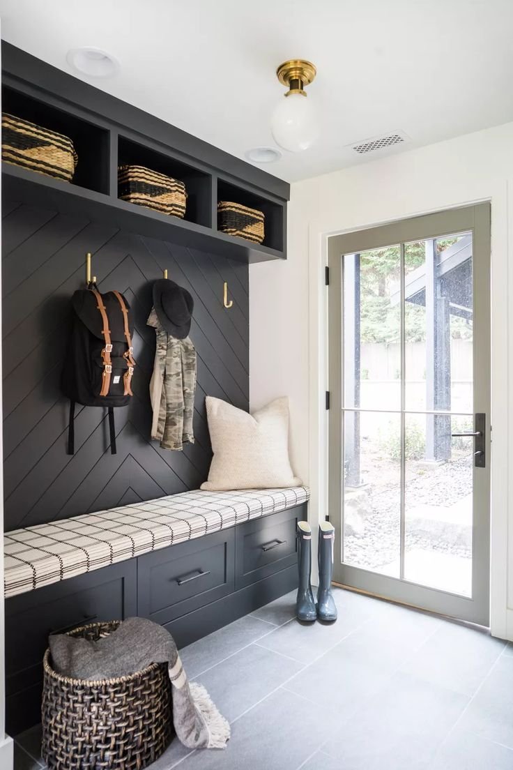 Black and white mud room with built in shoe storage. 