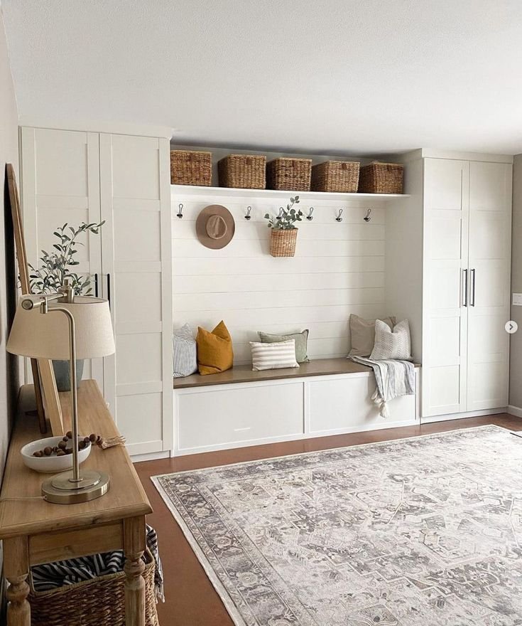 Large mud room with lots of storage in a white color. 