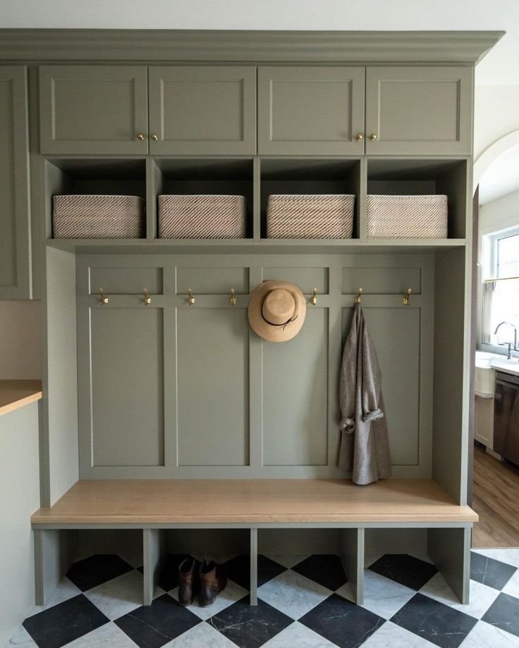 Practical mud room design in a green color. 