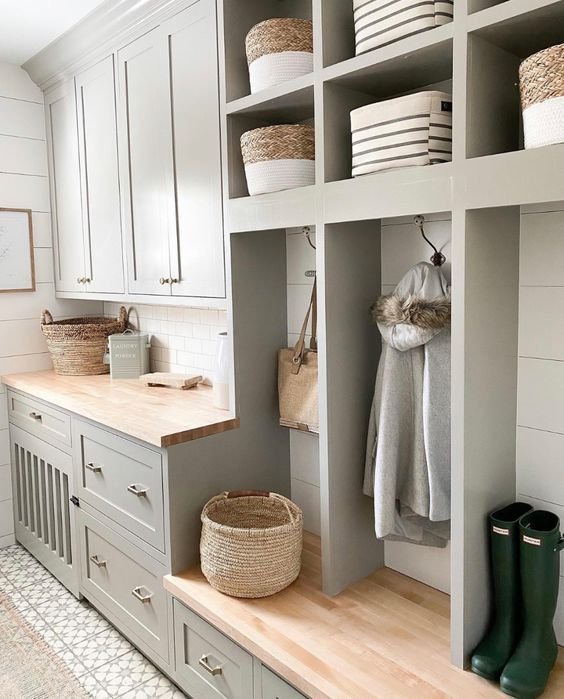 Built in bench with storage in mud room, green color. 