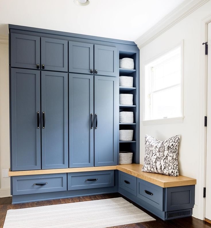 Large blue closet with wooden details. 