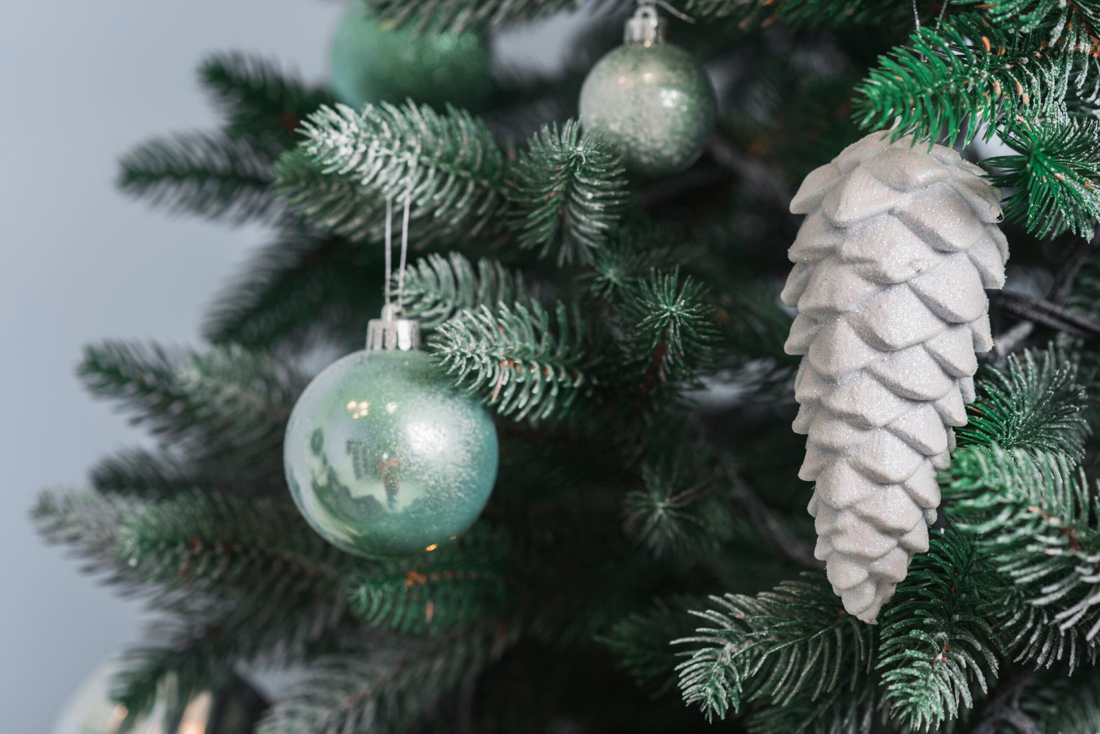 Christmas tree with pinecone and ornaments in it. 