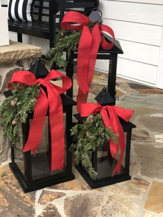 Outdoor lantern with red bow and fir twigs.