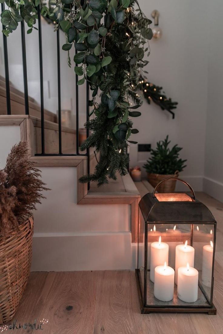 Christmas hallway decor with lanterns and a green garland. Christmas hallway decorating ideas.