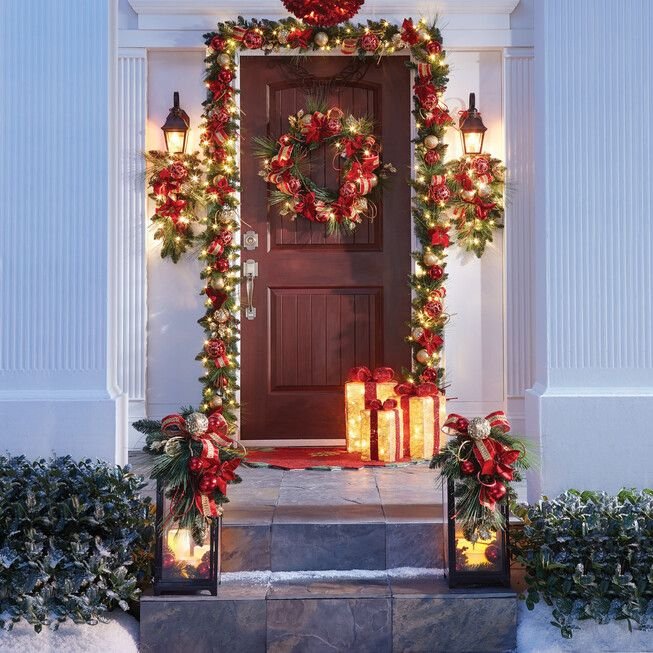 Christmas porch with lanterns and lighted gift box. 