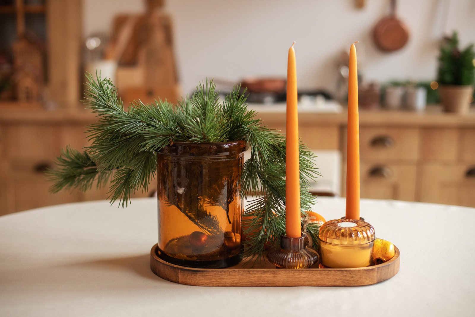 Christmas decorations on a kitchen counter with scented candles. 