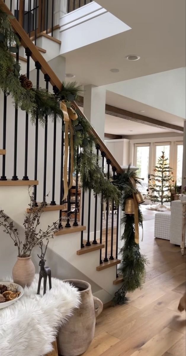 Christmas decorated staircase with a garland and bells. 