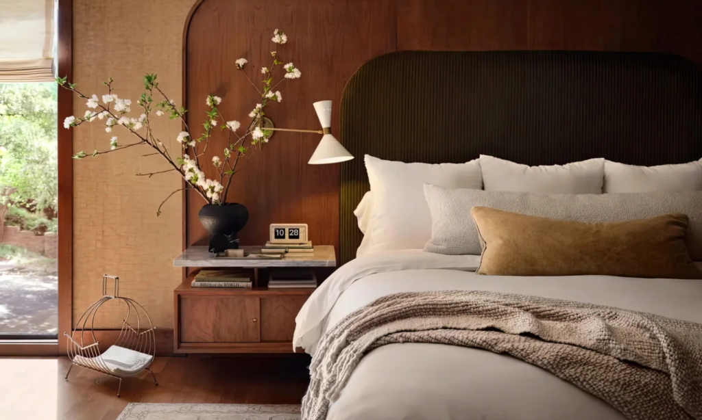 Mid century modern bedroom with wooden details and a vase with flowers.