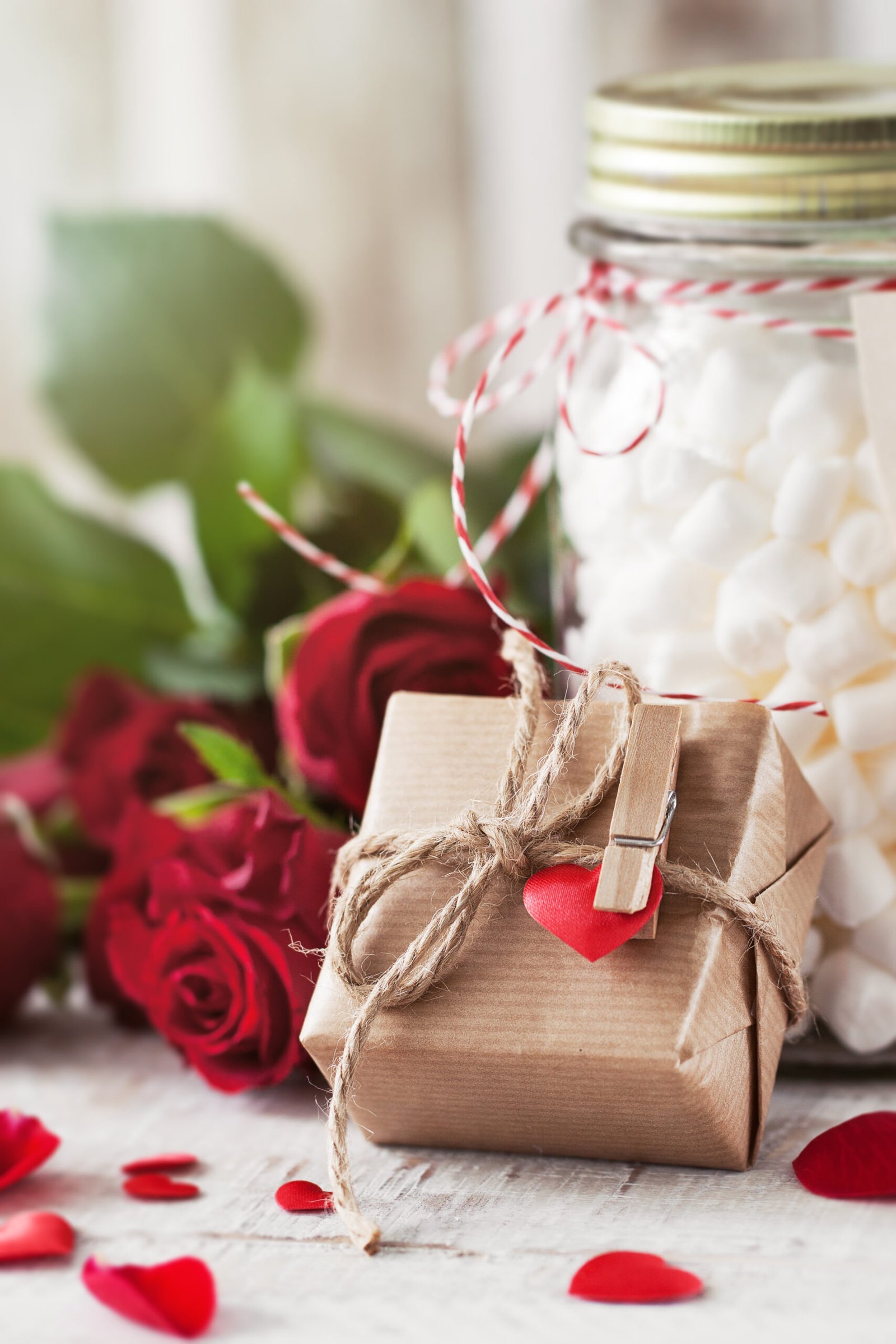 Small gift or present in natural paper with small heart and roses, love or valentine's day concept