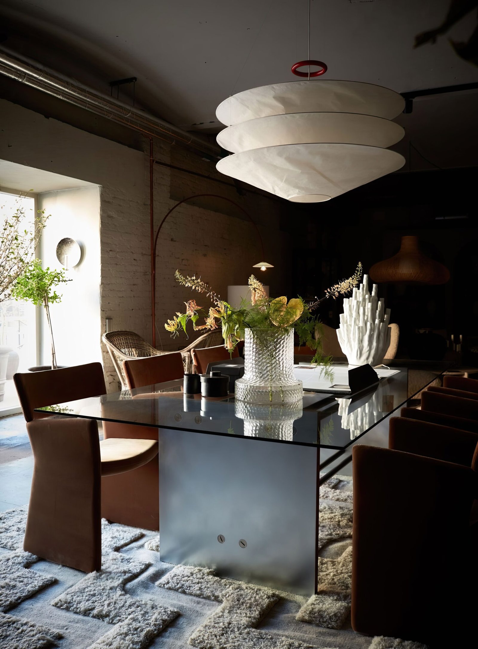 Kitchen table with chairs and a big bold statement lighting. 