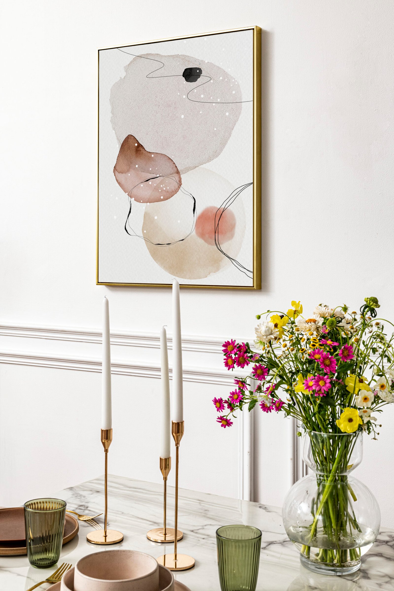 Dining table in a modern boho chic aesthetic dining room, flowers and candle sticks on the table. 