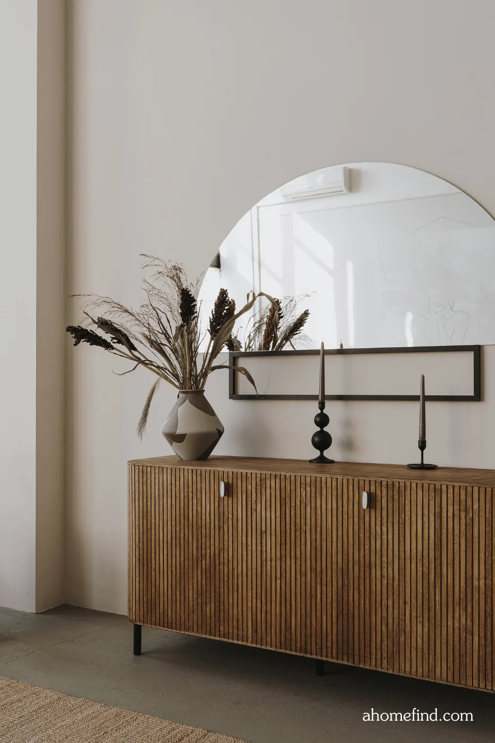 affordable small space decorating tips and second hand shopping. Wooden sideboard with a mirror above it. 