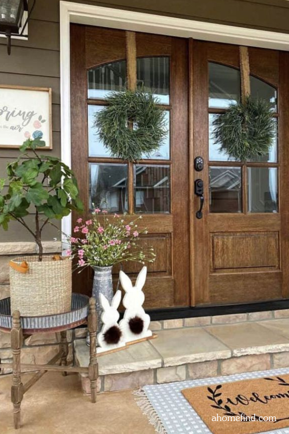 Floral front porch arrangements and Farmhouse spring porch decor. A large front door with Spring wreath for front door. 