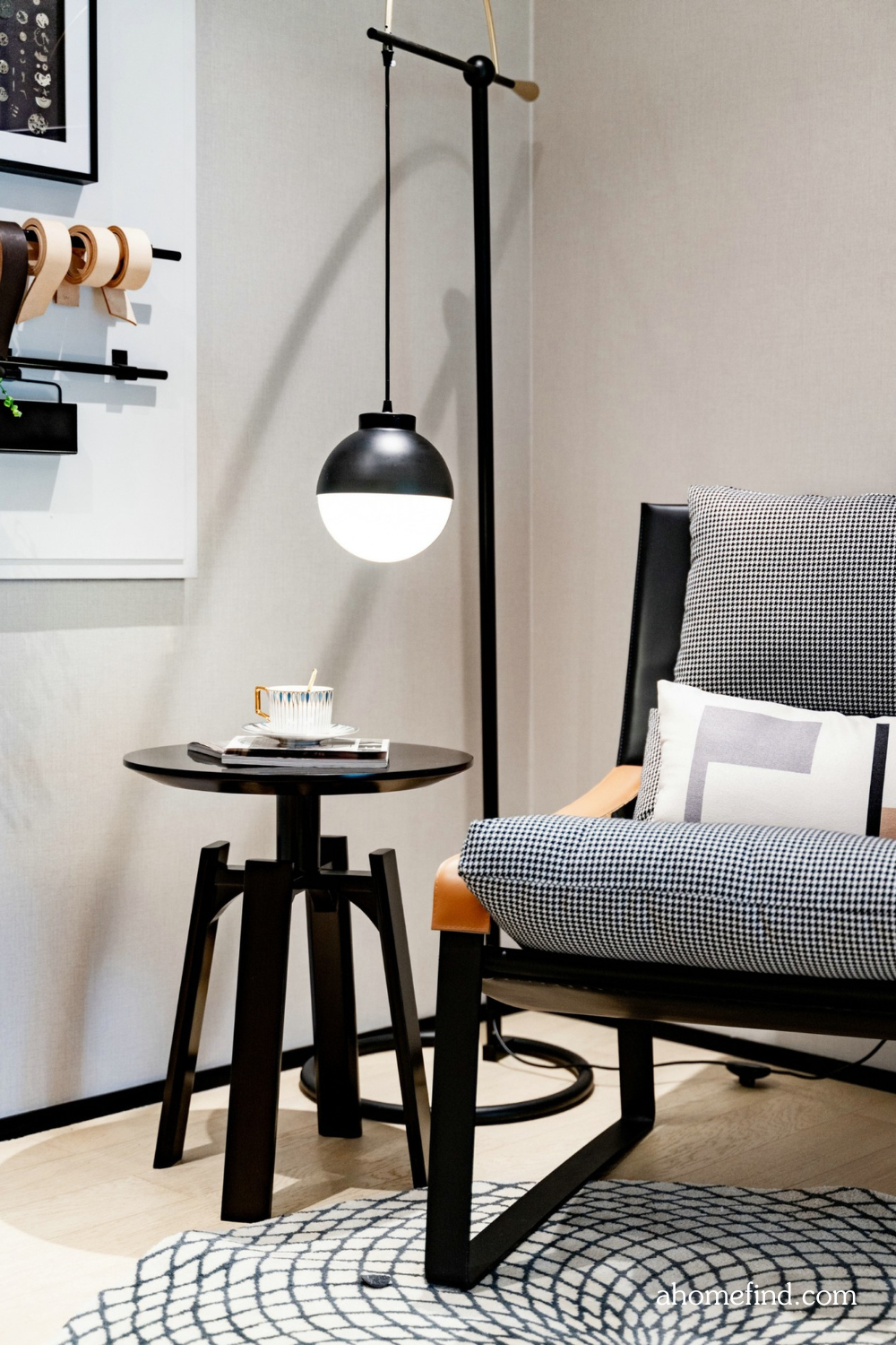 Best lighting for living room with an armchair in the corner and a black sideboard and a black floor lamp.