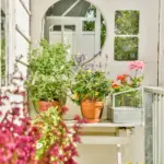 Pastel color porch decor and Outdoor seating ideas for spring with Floral front porch arrangements.