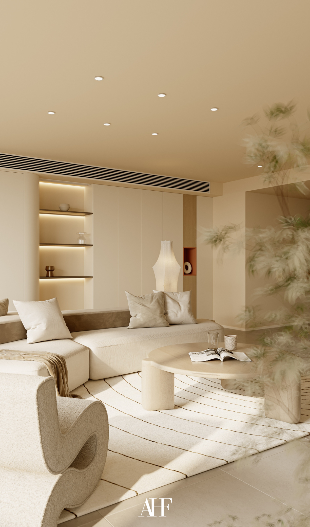 A minimalist living room with a white rug and a beige sofa.