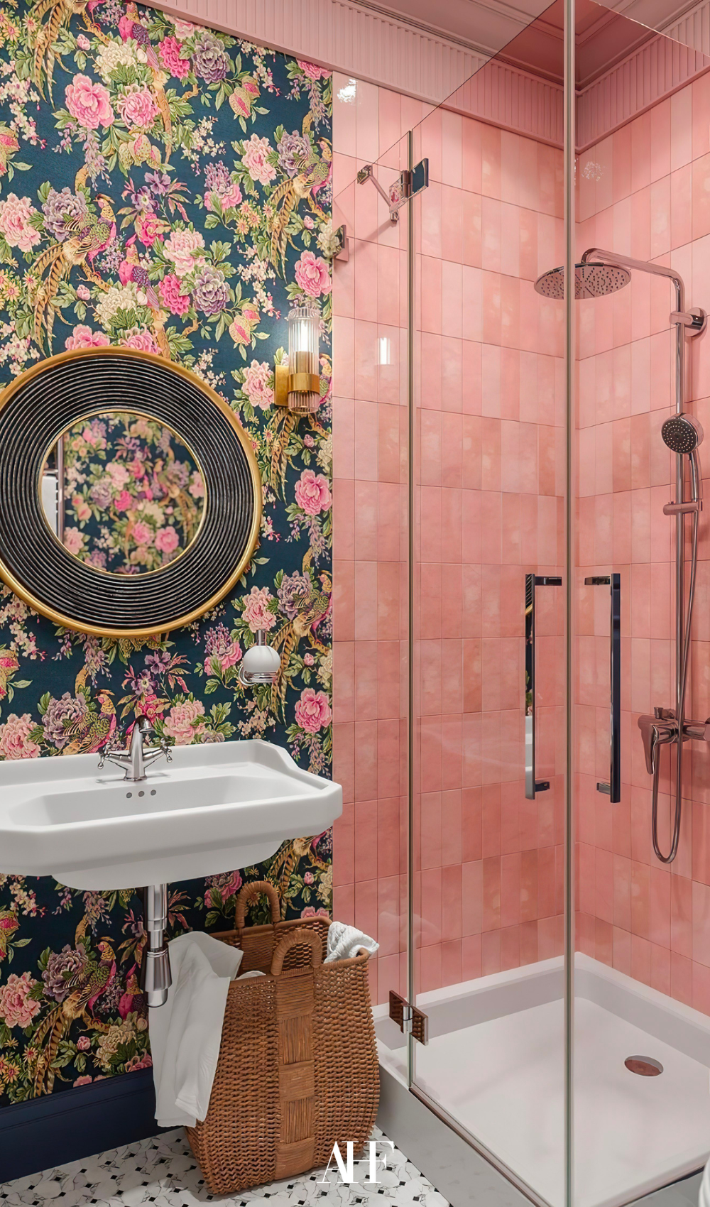 A maximalist bathroom with pink walls and a floral wallpaper. A shower and bold interior design.