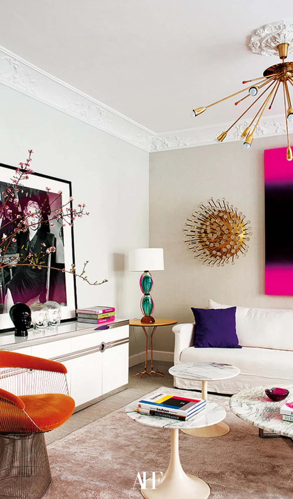 A neutral maximalist interior design living room with pops of colors. White couch and bold interior design.