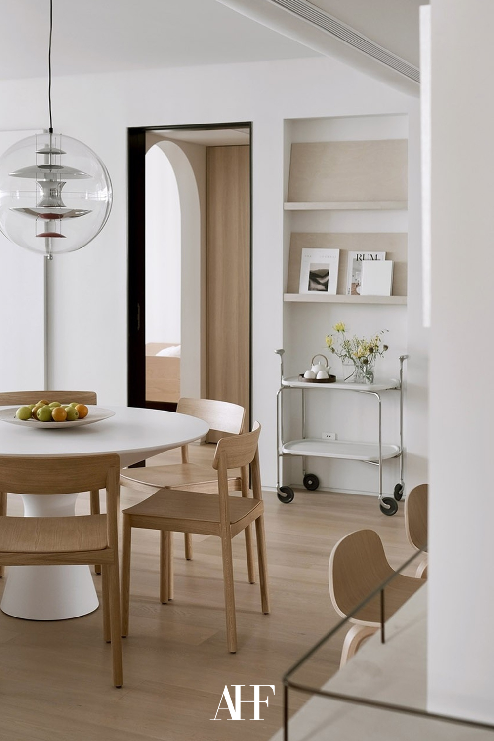 Scandinavian interior design with a dining table and wooden dining chairs. Scaled. Interior design styles.