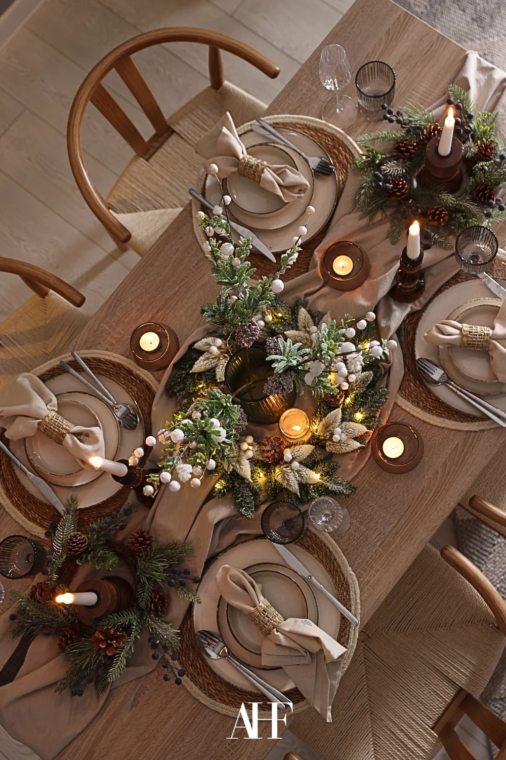 A beautiful dinner setup with rustic details, a wooden table and beautiful decorations.