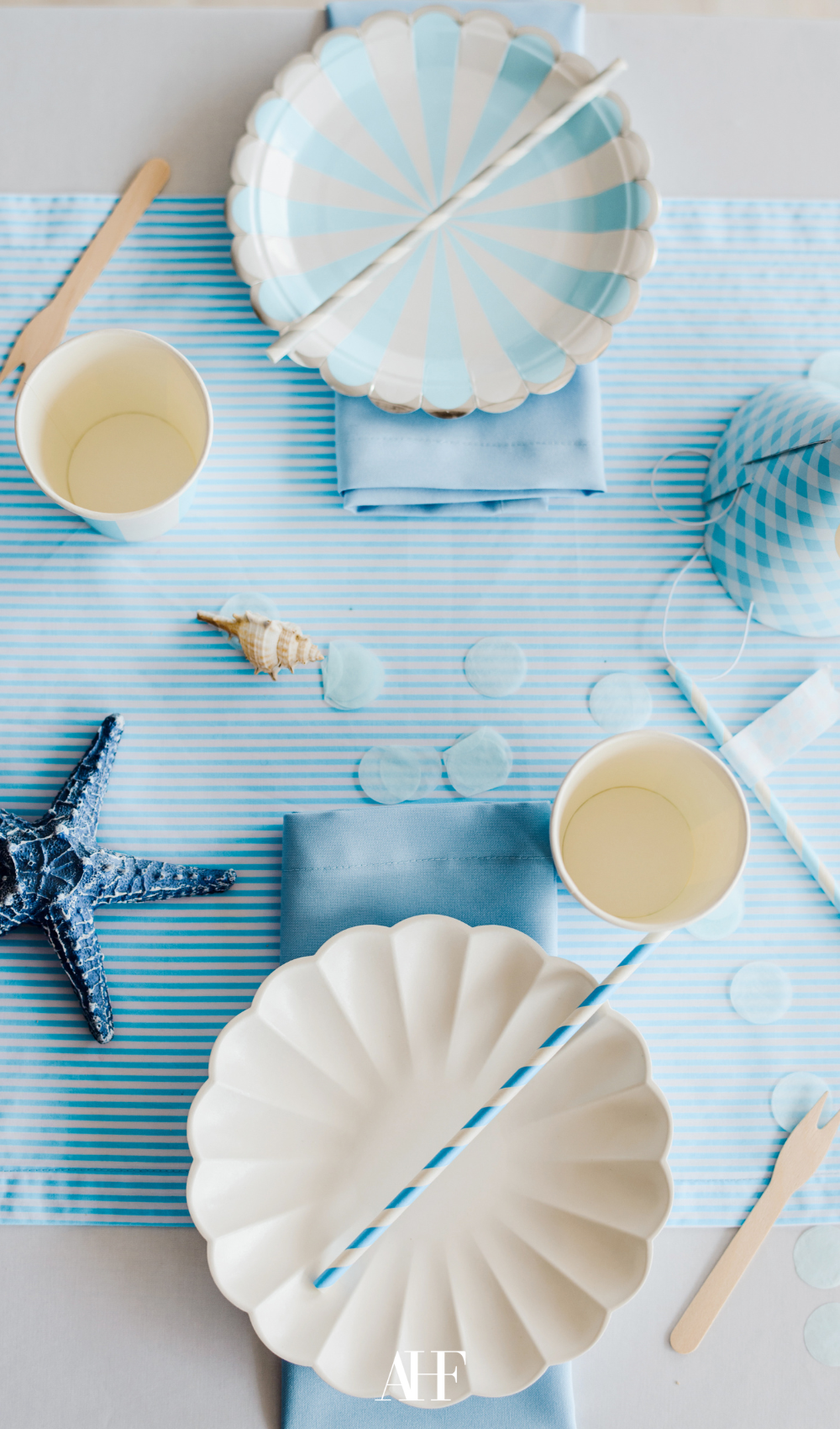 coastal theme summer dinner setting with coastal blue details and a sea star.