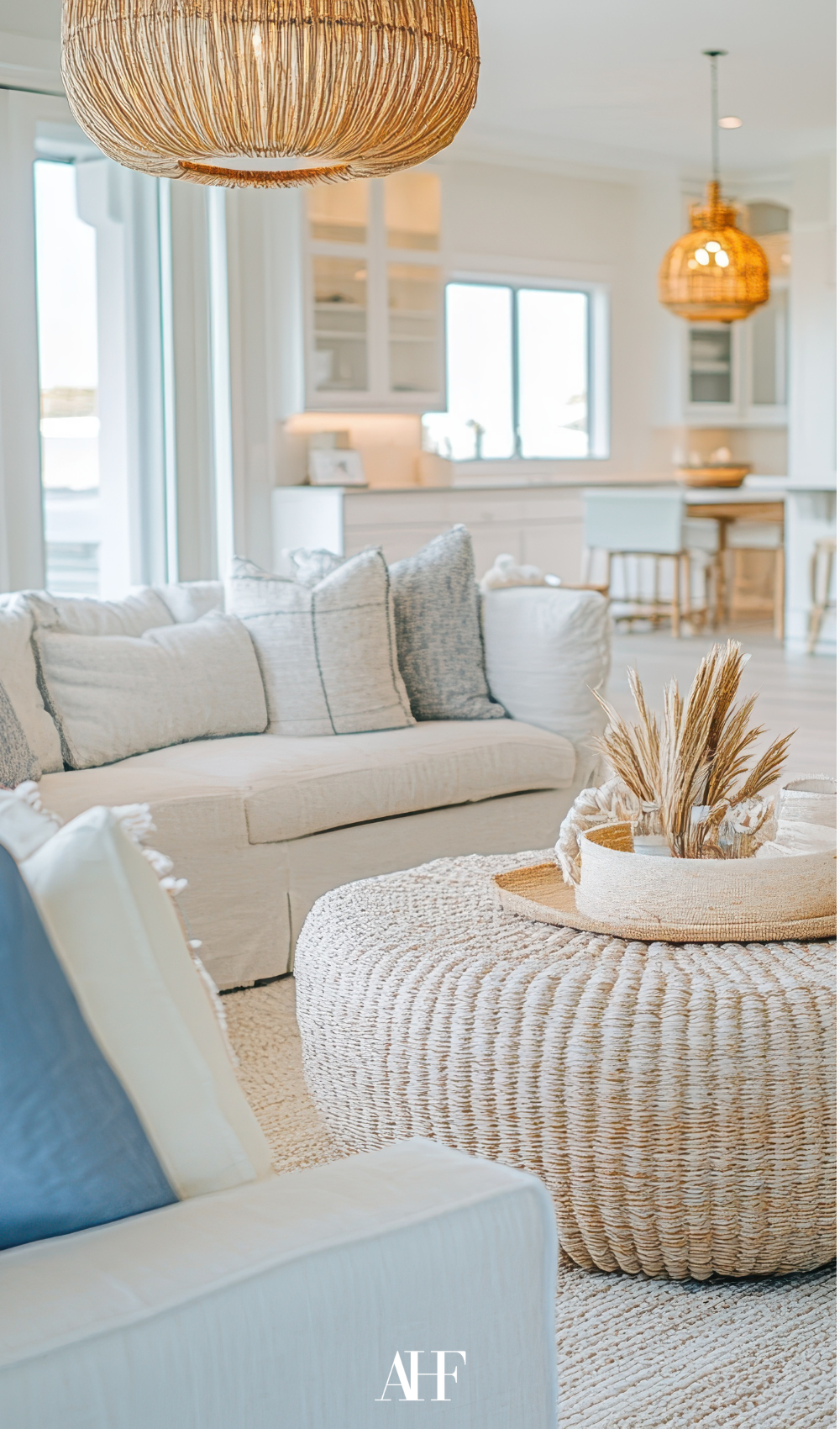 Coastal interior design with a white sofa, a coffee table and some coastal blue decorations.