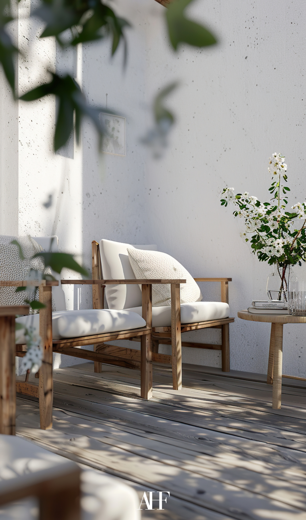 scandinavian small summer patio with wooden furnitures and white pillows. Some plants.