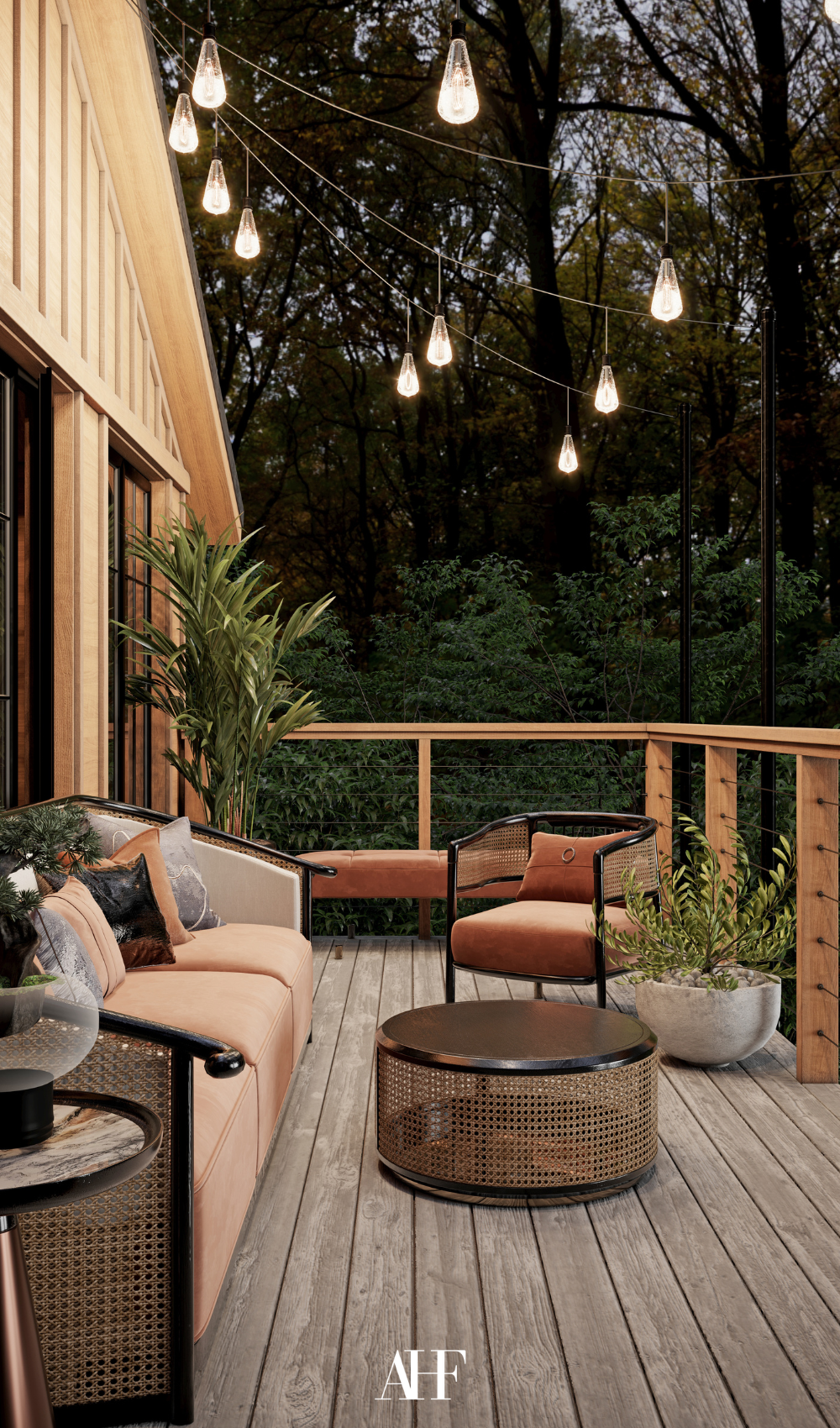 A beautiful patio with summer wind patio furniture and cozy string lighting. Woods in the background.