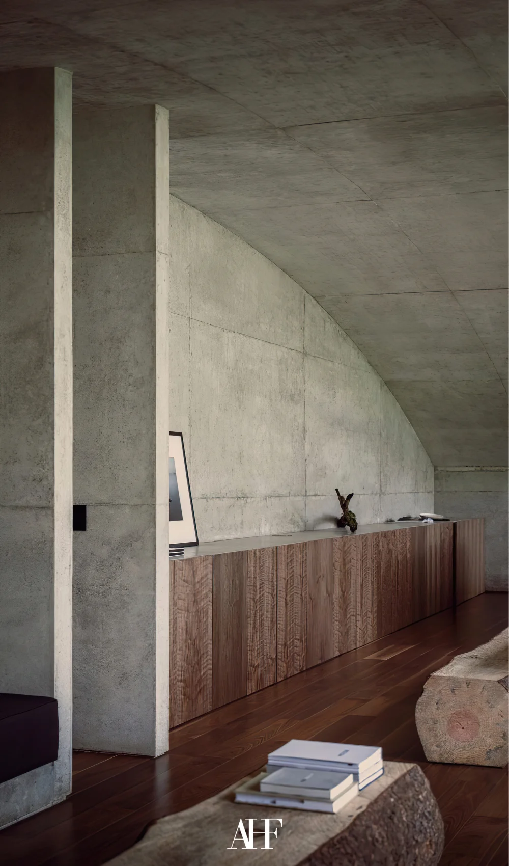 A concrete wall with wooden cabinets and decorations on it. Industrial home.