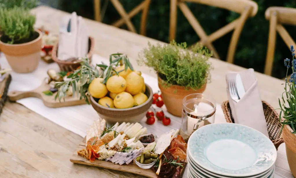a summer dining table setting and with some food on it.