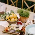 a summer dining table setting and with some food on it.