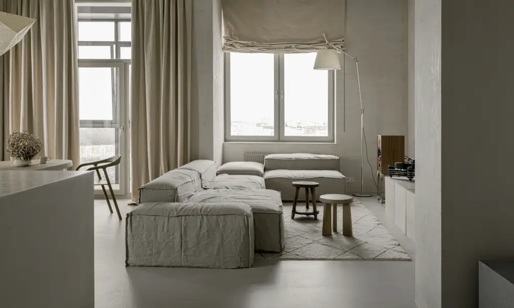 A living room with a linen sofa and linen curtains. beige colors and neutral decor. Summer window treatments.