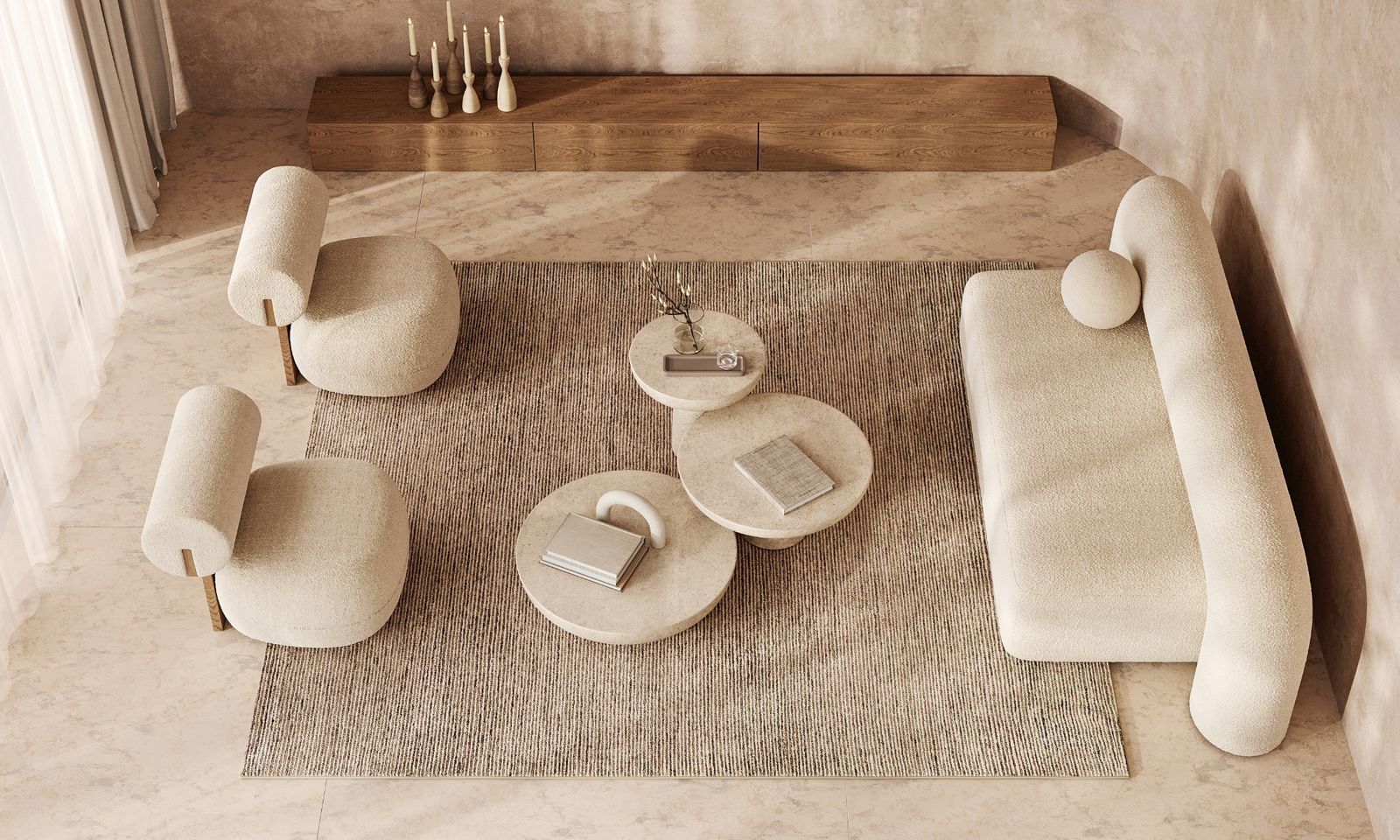 A cozy living room with a beige sofa, two beige armchairs and a seof three coffee tables. A perfect rug to tie the space together and a wooden bench.