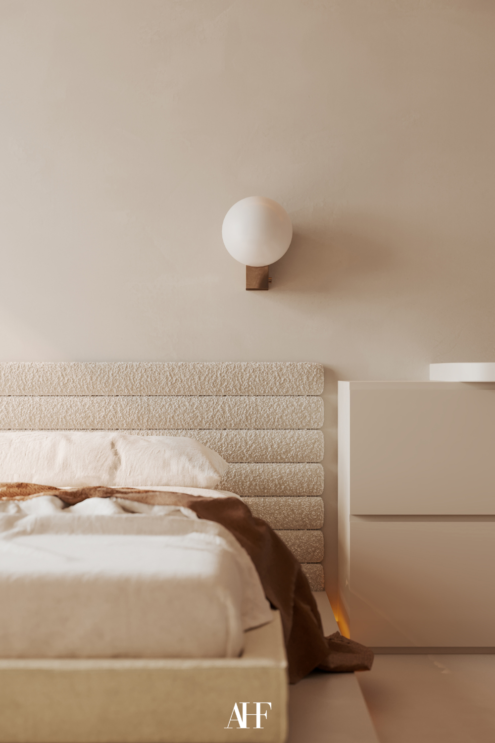 A neutral and calm bedroom with a beige bed frame and rust details. 