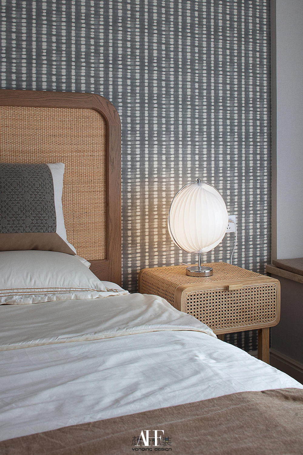 Japandi style bedroom with a wooden bed frame, a wooden bedside table and a silver table lamp. White bedding and japandi bedroom decor.