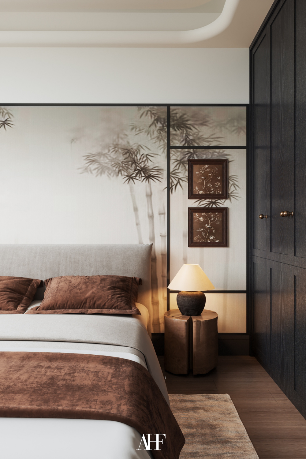 Beautiful japandi style bedroom with a neutral bed and rust bedding details. A black wardrobe to the right and a bedside table with a table lamp and some wall art above it. Beautiful japandi bedroom decor.