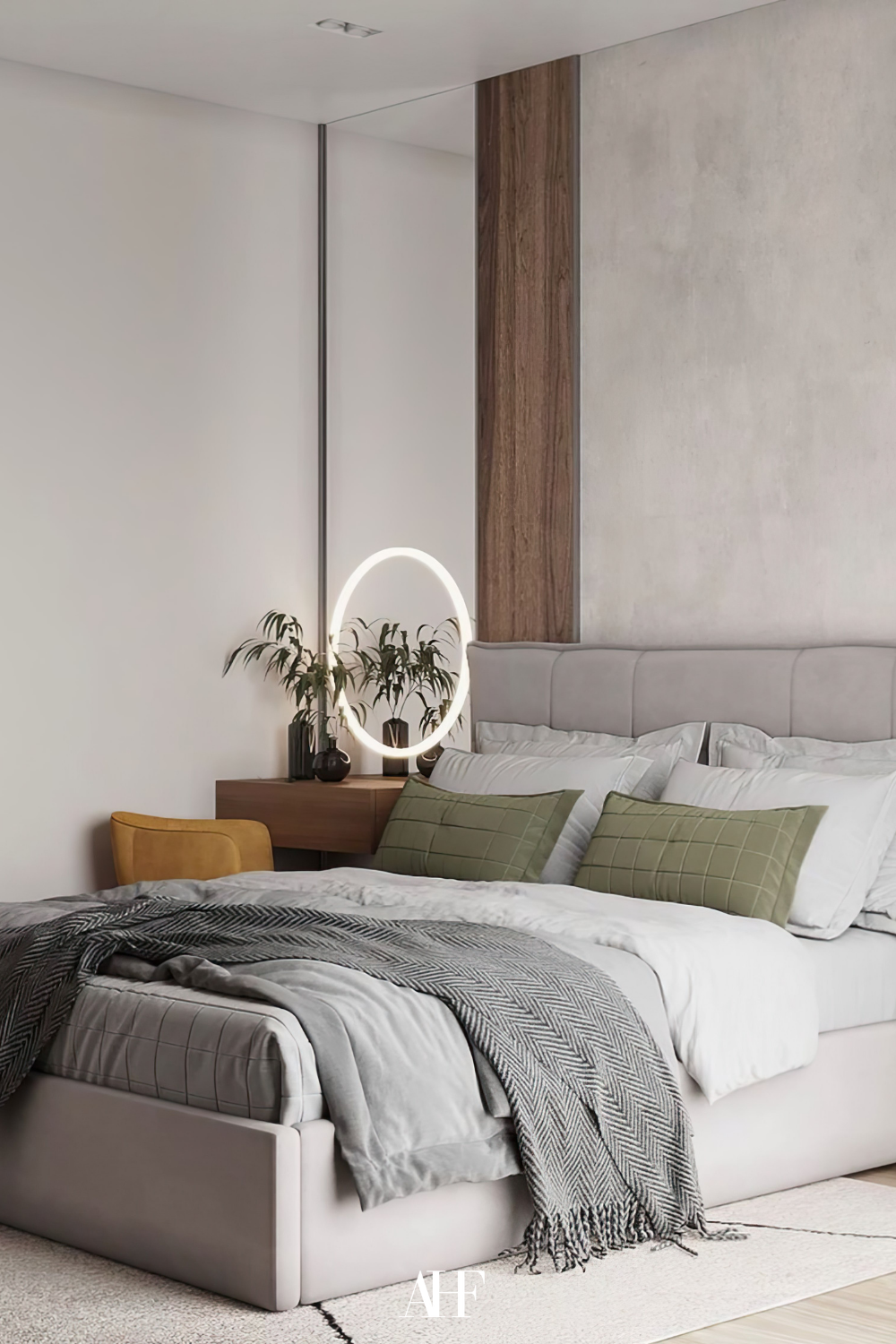 A bedroom with beautiful Japandi bedroom furniture. A wooden desk to the left of the bed with a mustard chair. A grey bed and white bedding. Wooden details on the wall.
