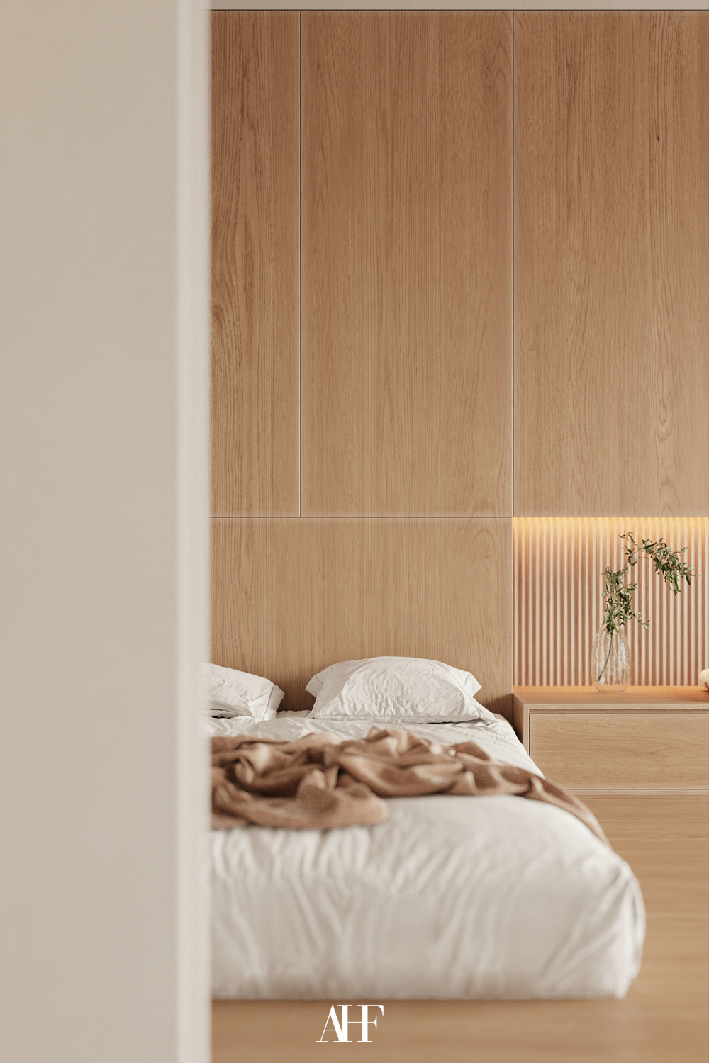 Massive wooden wall with a wooden bedside table, a bed with white bedding. Japandi bedroom ideas.