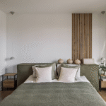 Japandi bedroom ideas with green and wooden details. A large window to the right and japandi bedroom decor.