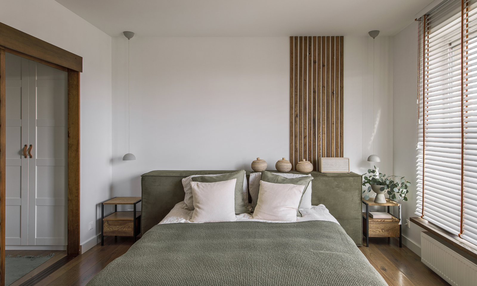 Japandi bedroom ideas with green and wooden details. A large window to the right and japandi bedroom decor.