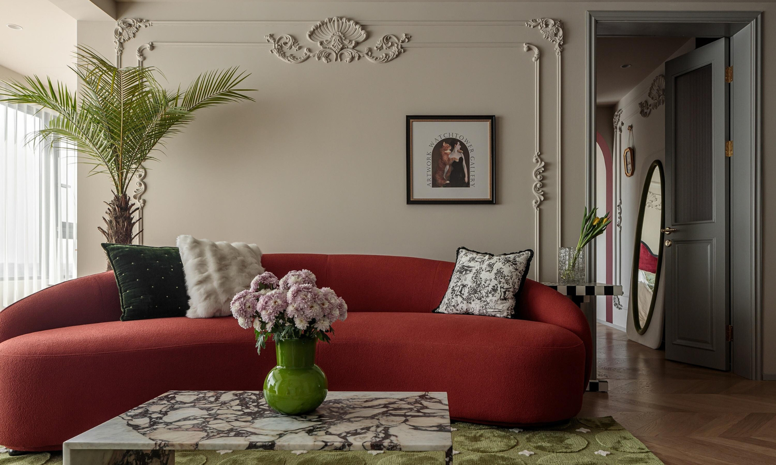 Cherry coded interior with a large cherry red sofa and a marble coffee table and a green rug. Beautiful interior, cherry coded home.